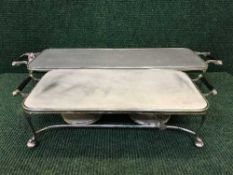 A mid twentieth century twin handled warming plate, with three spirit burners,