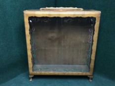 A mid twentieth century walnut sliding glass door display cabinet