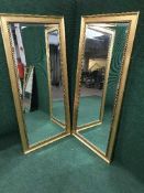 A pair of 5' gilt framed bevelled mirrors