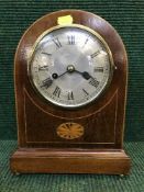 A Victorian inlaid mahogany domed topped clock