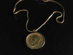A 1911 Sovereign with 9ct gold mount (9.1g), upon an 18ct gold chain (4.