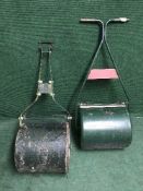 A vintage garden roller together with one other