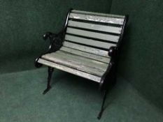 A wrought iron and wooden slatted garden chair
