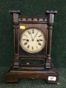 A 19th century German mantel clock in mahogany case (with pendulum and key)