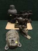 A tray of two wooden Buddha heads, wooden buffalo bookends,