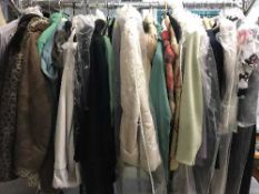 A rail containing a quantity of lady's clothing - Jackets and coats