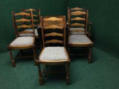 An oak gateleg table together with a set of five ladder backed chairs