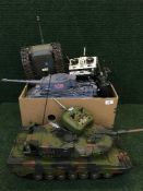 Five remote controlled tanks with control hand sets