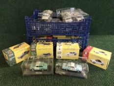 Two baskets of die cast vehicles including boxed Atlas sports cars and assorted die cast police