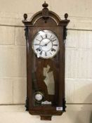 A mahogany and walnut thirty-one day wall clock