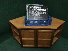 A Nathan teak corner tv stand together with a crate of assorted lps including compilations,