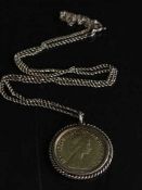 A 1982 half sovereign on 9ct gold chain, 8.