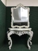 An ornate cream two-piece console table/mirror