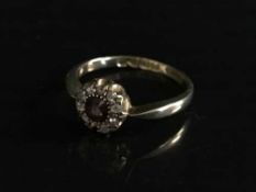 A 9ct gold diamond and garnet cluster ring (one diamond lacking), 2.