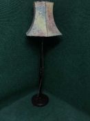 A mahogany standard lamp and shade