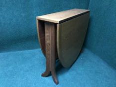 A narrow teak drop leaf table