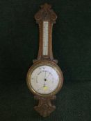 A carved oak barometer