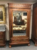 A late Victorian mahogany mirror door wardrobe