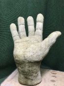 A concrete garden seat in the form of a hand by Lucas Stone