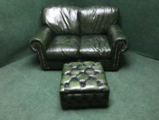 A green buttoned leather chesterfield two seater settee together with storage footstool