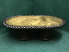 An oval rope table depicting a map of the world