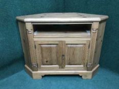 A pine double door corner cupboard with slide out computer tray