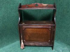 An Edwardian mahogany wall cabinet bearing Walter Carter,