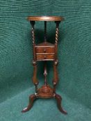 A mahogany wig stand fitted with two drawers