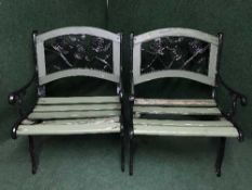 A pair of wrought iron and wood garden chairs