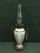 An early 20th century glazed ceramic and gilt bronze oil lamp depicting a figure of a Roman goddess