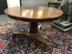 An early Victorian mahogany tilt topped breakfast table on tri-form base