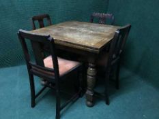 An early 20th century oak pull out table and four chairs