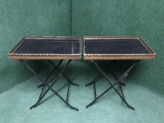 A pair of folding marble topped tables with metal galleries