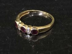 An 18ct gold three stone ruby and diamond set ring