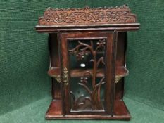 A carved curio cabinet