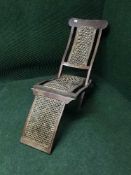 An early 20th century teak and cane seated lounger