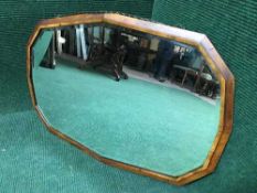 A shaped early 20th century mahogany mirror