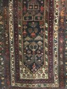 An early twentieth century fringe Persian rug on multicoloured ground and medallion borders.
