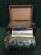 An early twentieth century chrome plated barrel clock, with key, in stained pine box.