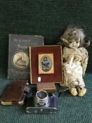 A crate of collectables including porcelain doll, old camera, carved box,