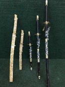 A set of three graduated Samuri style swords and two others