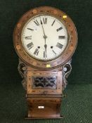 A Victorian inlaid mahogany wall clock with pendulum and key