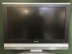 A Sharp Aquos 32 inch lcd tv with remote