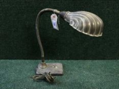 An early twentieth century angle poise lamp with shell shade