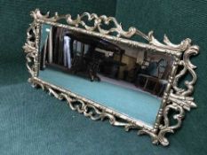 A late 19th century ornate gilt framed over mantel mirror