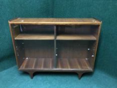 A teak sliding glass door bookcase