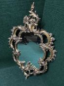 An ornate gilt Rococo style mirror
