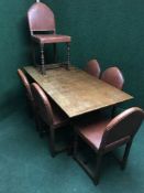 An oak refectory dining table and six leather upholstered chairs