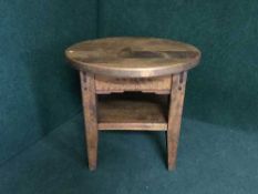 A circular pine two tier coffee table