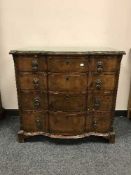 A mahogany serpentine fronted four drawer chest with glazed top